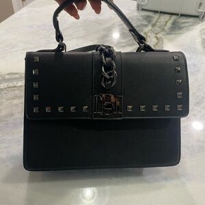 Black leather purse with top handle and removable shoulder strap